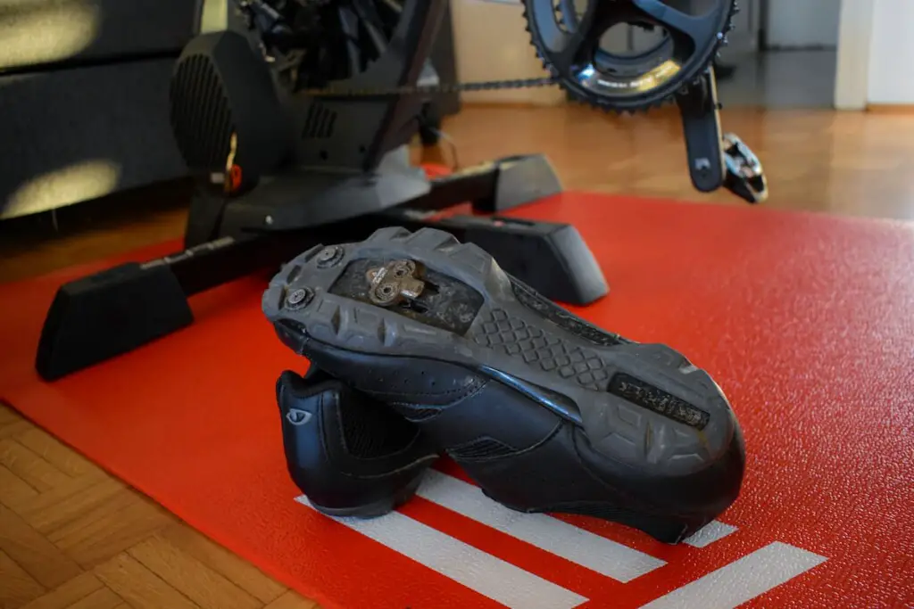 Cycling shoes on a trainer mat