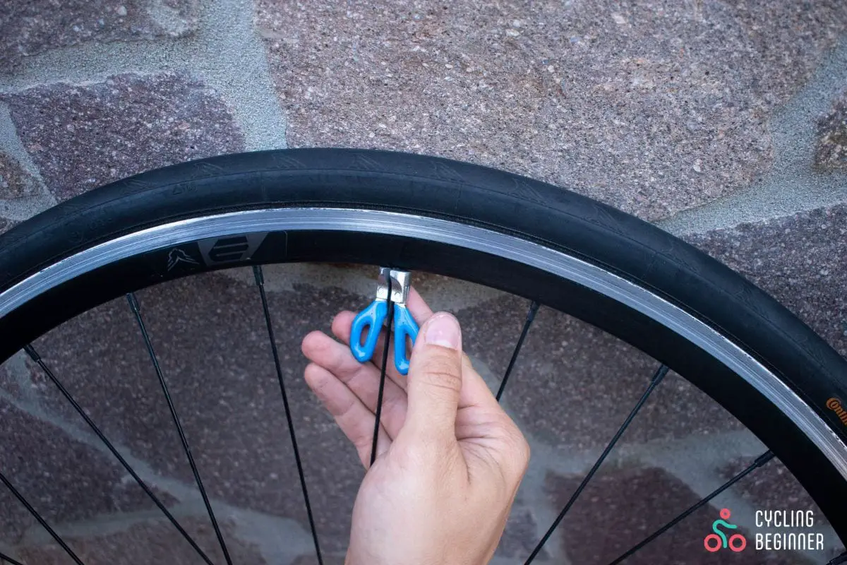 Tightening the spoke with a spoke wrench